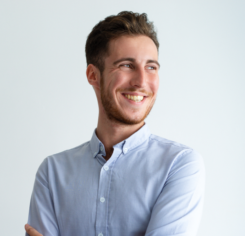 young smiling man with dark hair in a light shirt